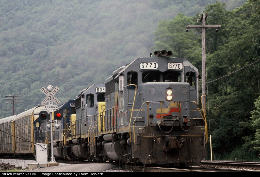 CSX 6770 leads autoracks west passing by Potomac St's grade crossing